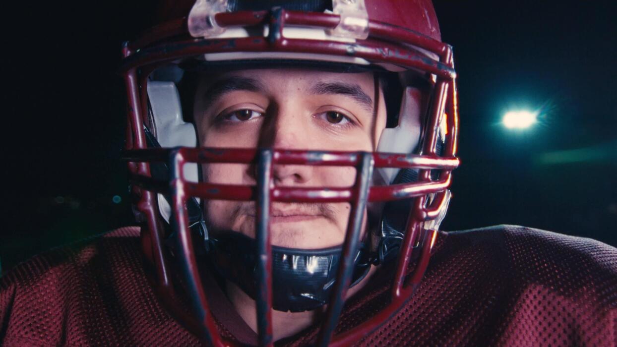 Young football player under dramatic lights
